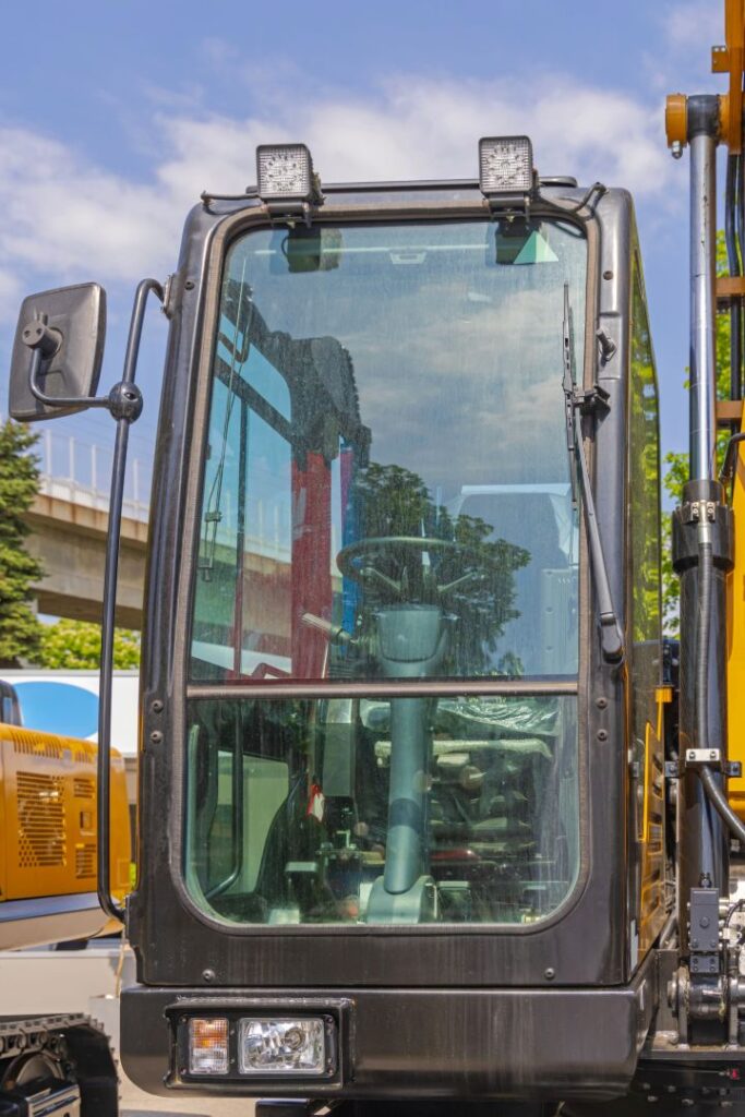 Front Windshield Glass Of Excavator Machine Driver Cabin.